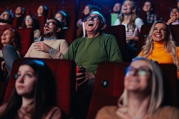 Diverse audience watching movie in cinema.