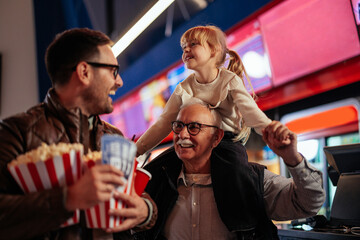 Cheerful multigenerational family in cinema.