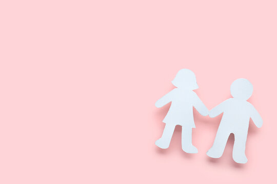 Male and female human figures holding hands on pink background. Friendship Day celebration