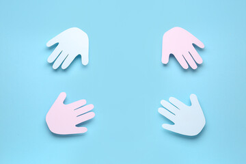 Frame made of paper palms on blue background. Friendship Day celebration