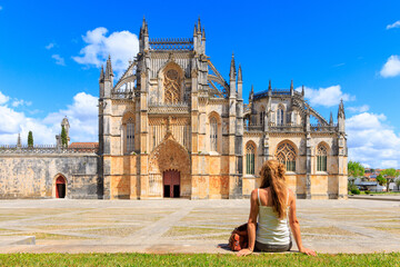 Woman tourist traveling in Portugal- Batalha Monastery- Gothic style