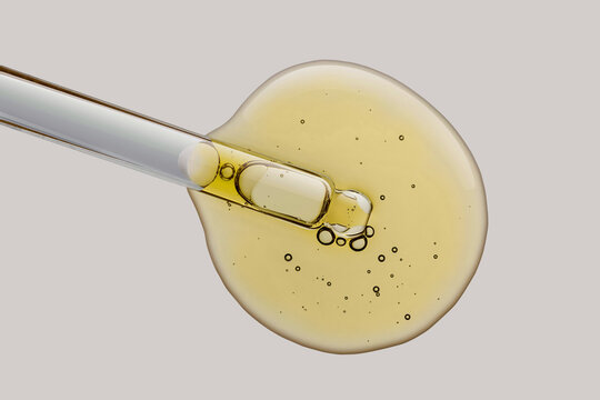 Cosmetic texture serum emulsion drop with pipette dropper yellow
