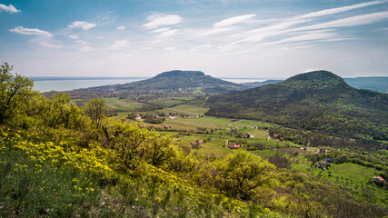 Badacsony Hill and Gulács Hill in the spring, Badacsony wine region with the Lake Balaton in the background from Tóti Hill - 596608801
