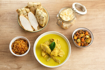 Opor Ayam, served with ketupat, sambal goreng ati, keripik kentang and emping. Popular during Eid al Fitr. Indonesian traditional food
