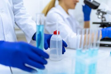 Fototapeta premium Scientists examining liquid in test tube in laboratory