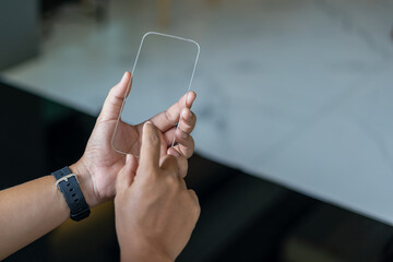 Man holding device and touching screen on smartphone.