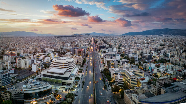 Aerial view of the skyline of Athens, Greece, during sunset time with Syggrou Avenue leading from the south suburbs in to the city center