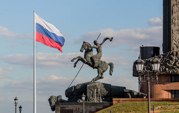A fragment of the Victory Monument on Pobediteley Square in Victory Park on Poklonnaya Gora. Monument to George the Victorious on the background of the flag of Russia.Tricolour. Moscow. Russia, 2023