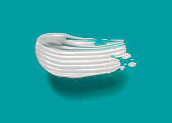 Face or body white cream hair balm or thick clay mask emerald blue background with big shadow