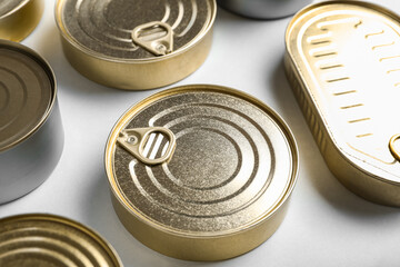 Assortment of tin cans with fish on white background