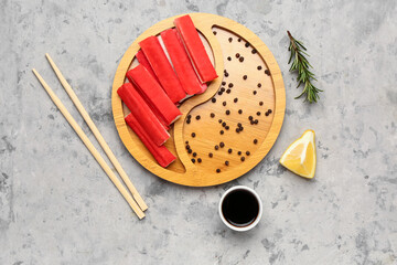 Plate with tasty crab sticks and sauce on grunge background © Pixel-Shot