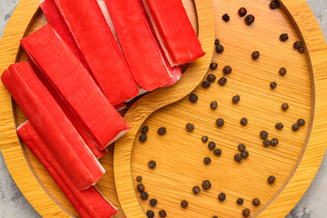 Wooden board with tasty crab sticks on table, closeup © Pixel-Shot
