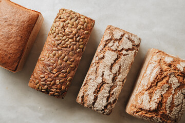 Various kind of bread with wheat top view. White bakery food concept panorama or wide banner photo.