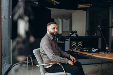 Portrait of happy young man working as radio host at radio station