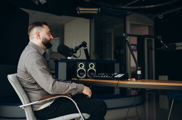 Portrait of happy young man working as radio host at radio station