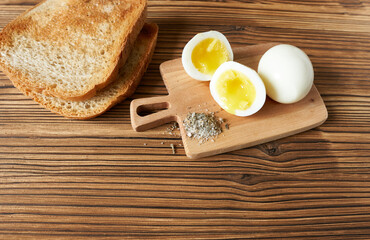 Fried toast and boiled eggs on the table, top view. The concept is breakfast cooking.