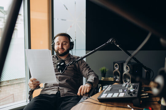 Portrait of happy young man working as radio host at radio station
