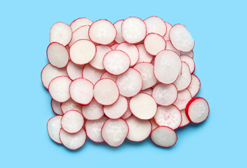 Slices of fresh radish on blue background