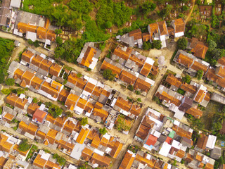Fototapeta premium Aerial photography. Aerial drone view of one residential at Bandung city - Indonesia, with green fields and many houses