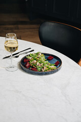 Healthy salad plate with quinoa, tomatoes, chicken, avocado, lime and mixed greens (lettuce, parsley) on wooden background top view. Food and health. Nutritious meal.