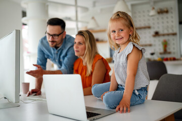 Happy family parent and child at home working on the computer. Business online work home concept.