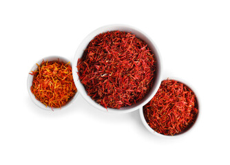 Bowls with pile of saffron on white background