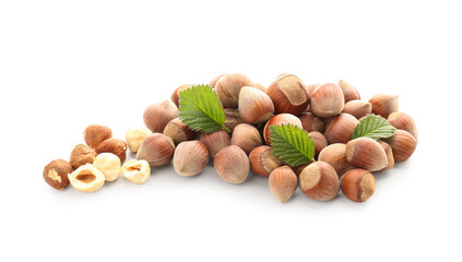 Shelled hazelnuts with leaves on white background