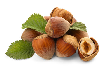 Shelled hazelnuts with leaves on white background
