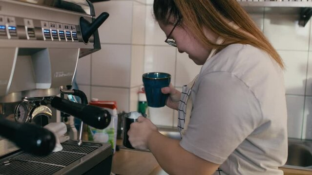 Down syndrome girl making coffee as a worker in the cafe. Shot with RED helium camera in 8K. 
