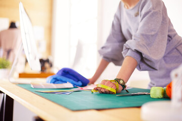 Fashion designer woman working on her designs in the studio.