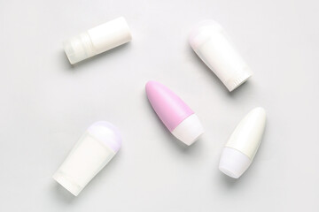 Different deodorant bottles on white background