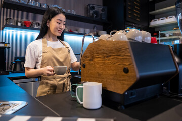 Focused cafe worker making a drink at the counter