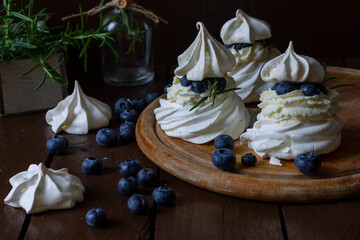 Pavlova dessert on a dark background