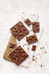 Sweet tasty chocolate with nuts on  light background