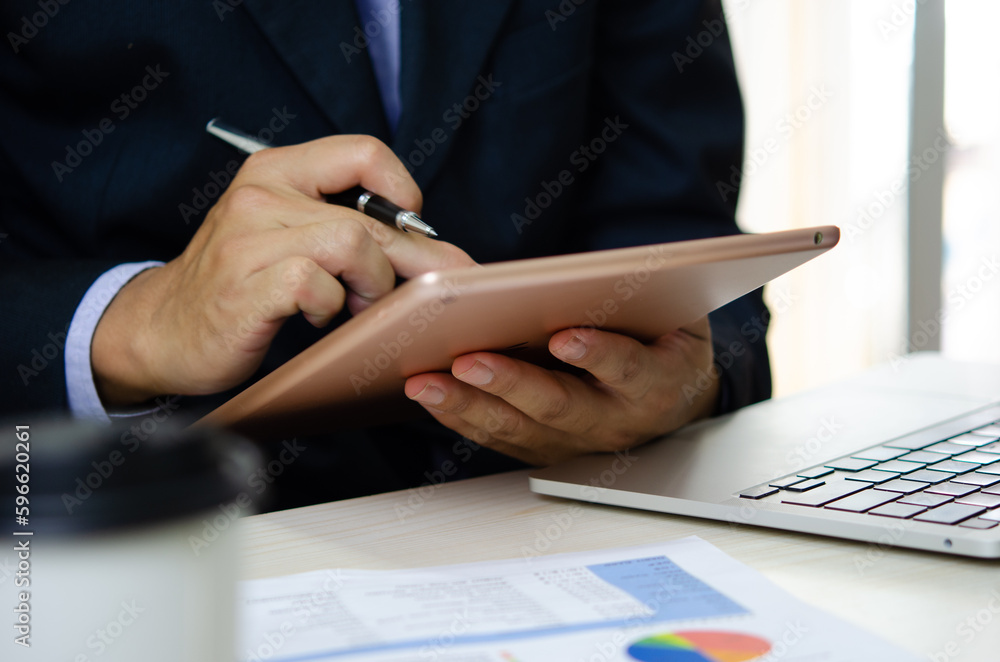 Poster businessman using tablet to analyze data and documents, business reports and work statistics with mo