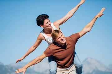 Couple in love opened their arms like the wings of an airplane. Trave concerts. High quality photo