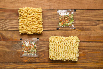 Fototapeta na wymiar Raw instant noodles with seasoning on wooden background