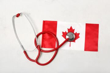 Flag of Canada with stethoscope on white background