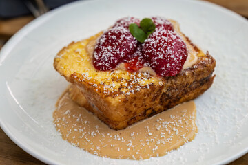 Strawberries on bread pudding with custard