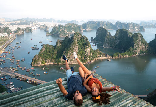 Backpacker couple enjoy trip through south east Asia with stunning view of Halong bay, Vietnam