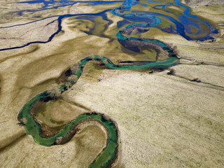 Aerial drone view of an amazing beautiful serpentine river. Vibrant colors and beautiful landscape. Background and textures. Nature and beautiful scenery. River Šuica in Bosnia and Herzegovina. 