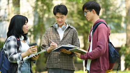 Group of students are talking to each other after classes while walking outdoors in university....