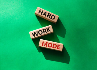 Hard Work Mode symbol. Concept word Hard Work Mode on wooden blocks. Beautiful green background. Business and Hard Work Mode concept. Copy space