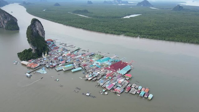 Aerial view over the floating fishing village at Ko Panyi (or Koh Panyee) one of famous travel destination in Phang Nga Bay, Phang Nga province, Thailand. 4K Footage video