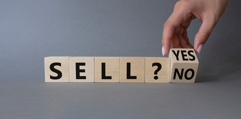 Sell Yes or No symbol. Businessman Hand turns cubes and changes words Sell No to Sell Yes. Beautiful grey background. Business and Sell concept. Copy space