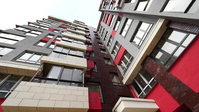 Looking up at the bright facade of a residential building on a cloud day