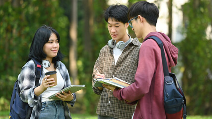Group of students are talking to each other after classes while walking outdoors in university....