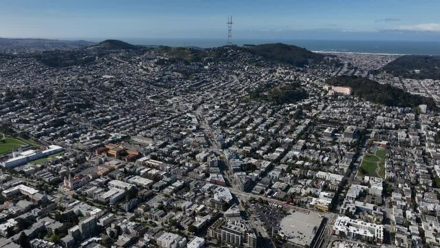 Aerial panoramic footage of houses in residential urban borough. Twin Peaks and Sutro telecommunication tower in background.