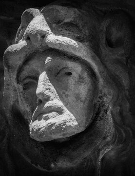 Fragment of an ancient stone statue of Hercules wearing Nemean lion skin.  Black and white image.