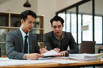 Asian business advisor meeting to analyze and discuss the situation on the financial report in the meeting room.Investment Consultant, Financial , teamwork ,brainstorming ,startup and accounting